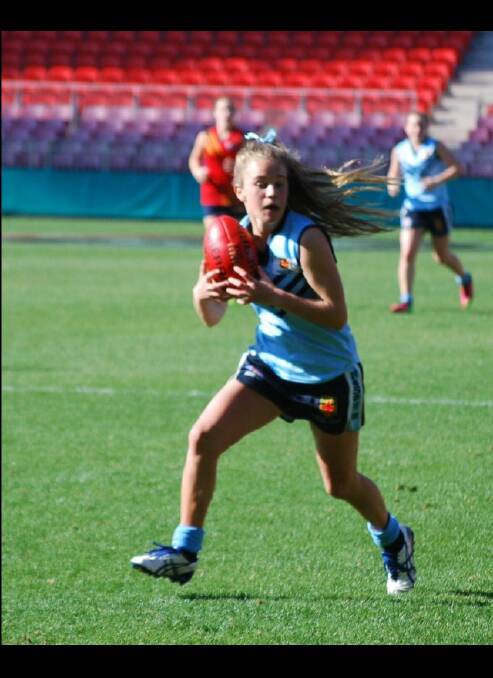 Bega Valley Aussie rules star Dakota Hooper takes a contested mark for NSW against South Australia, during a match where she was named best on ground at the recent national school championships in Sydney.
