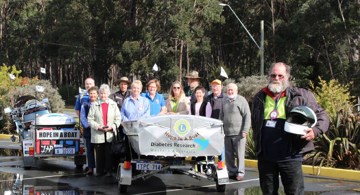 Albany, WA Lions member, Glen Hurst, front, who is towing a boat with a motorbike to raise funds for diabetes research with local Lions and his support team, Elizabeth Prosser, president, Pat Luker, Ron Russell, Raymond Cowcill, Carol Russell, Robyn Bedford, Marina Rurenga, Guy Cook, Sandra and Jim Rae and Neal Prosser. 