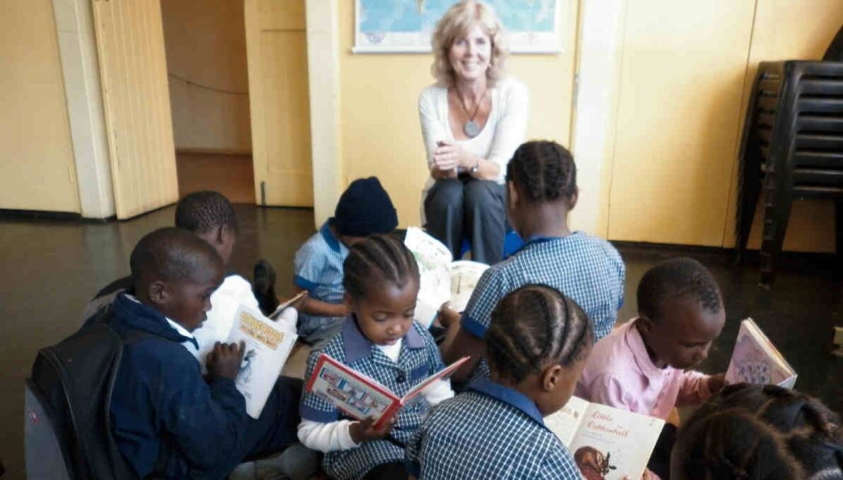 Libby Weir with students in the school library. 
