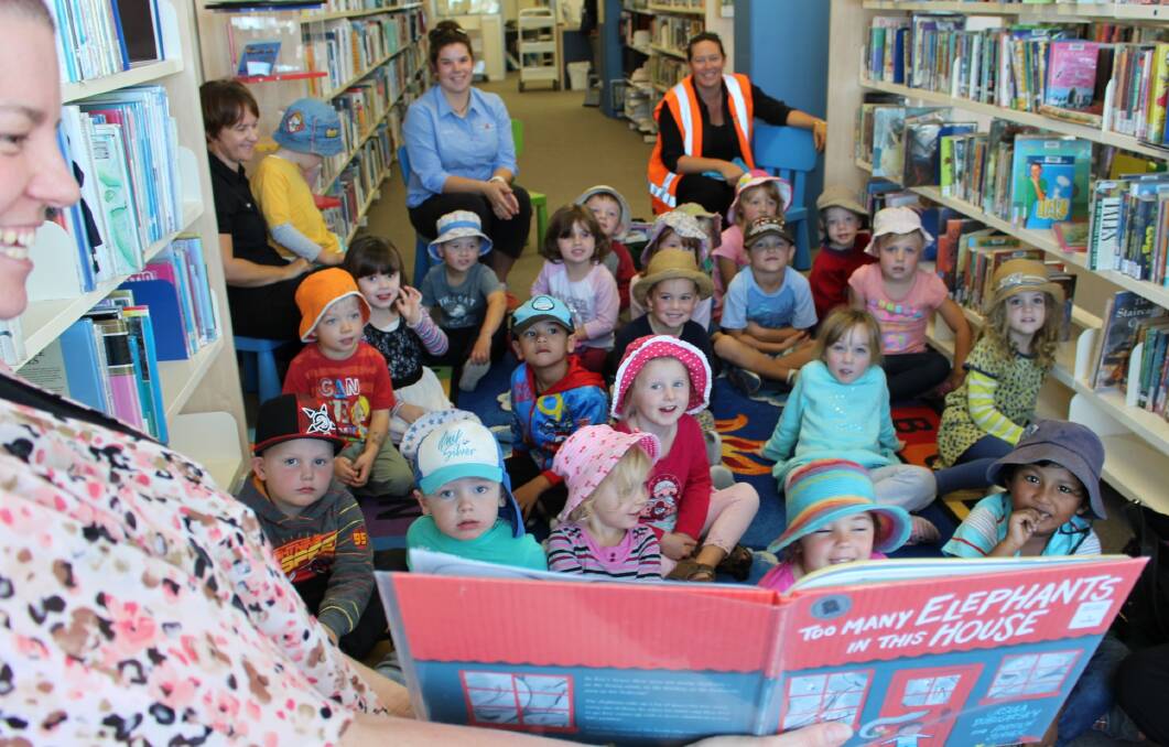 Assistant librarian at the Merimbula library, Rachael Higginbotham, reads the picture book ‘Too many elephants in this house’ to children from Little Nippers Early Learning & Childcare, Merimbula who participated in National Simultaneous Storytime.