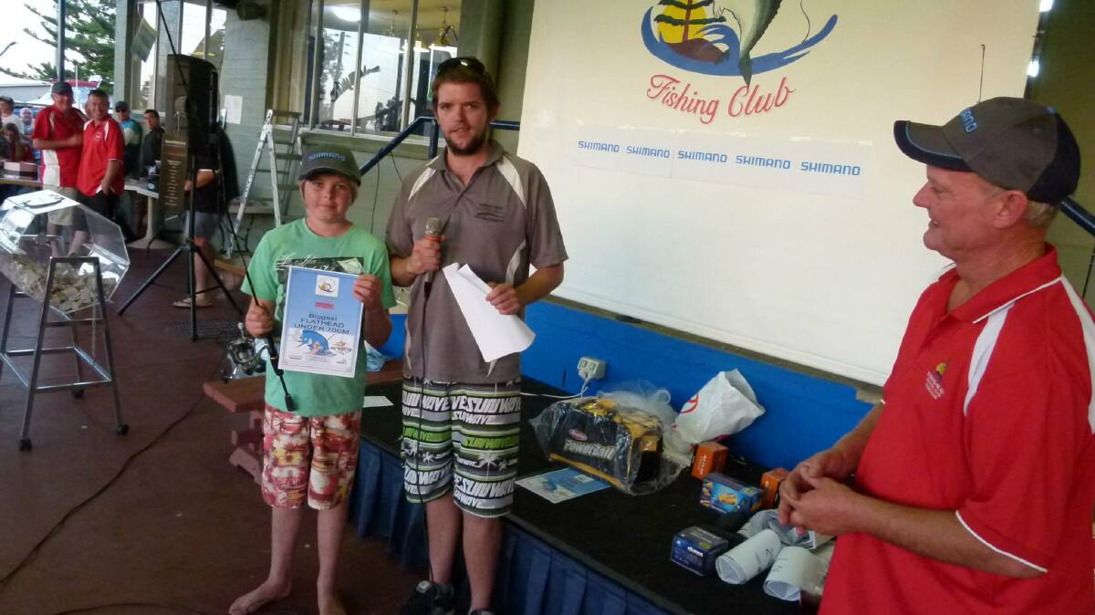 PRIZE TIME: Tim Gray presents Sam Gschwend with a prize at the Tuross Head Fishing Club’s Kids Hooked on Fishing day. 
