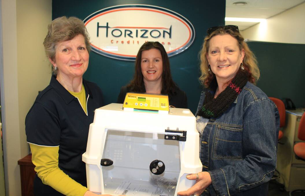 WIRES Far South East treasurer Margaret Shaw and wombat coordinator Shari Lea thank Horizon Credit Union branch manager Jess Porter for the humidicrib. 