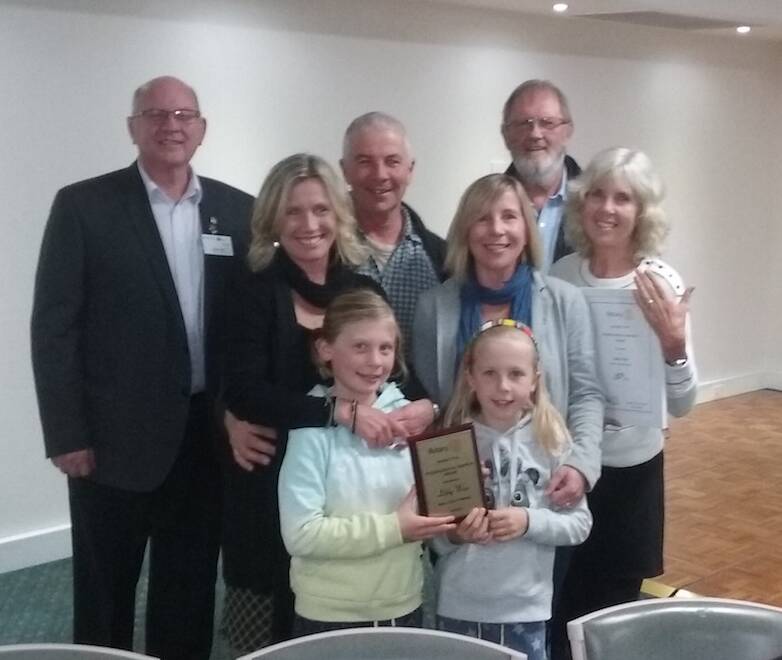 Service recognised: Steve Hill, District Governor with Libby's family Sarah, George, Emily, Pambula Rotary president Colin Dunn, Libby Weir and her granddaughters Abby and Rosie.