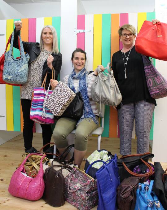 Jamie-Lee Tasker and Tracey Harris show off Phantasea's bag collection with Share the Dignity volunteer Alexia Talbot. 