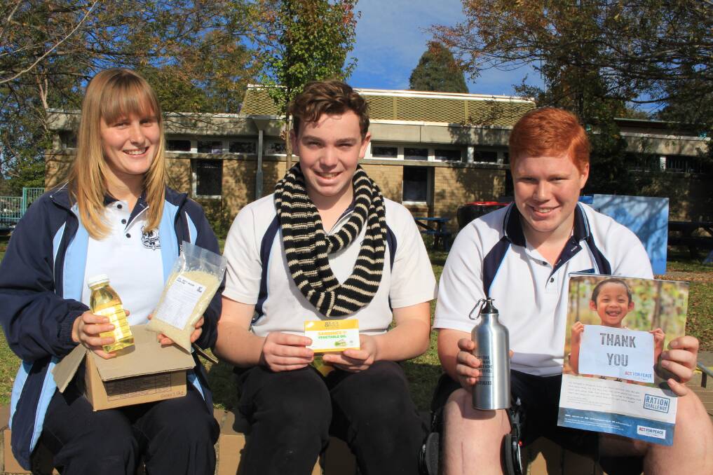Food for thought: Lucy-Sue Beukers, Zac Luimes and Tom Burn (Morgan Chapple absent) show off all the food they will be able to eat this week as part of the Act for Peace Ration Challenge. Picture: Melanie Leach
