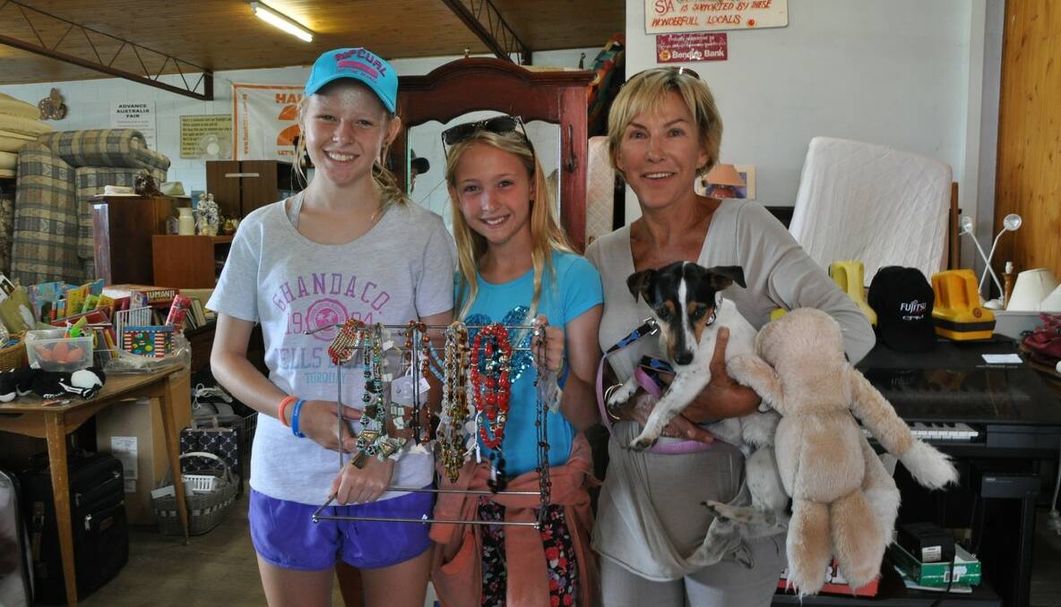 Megen, left and Rebecca Shaw, of Melbourne with Carol Cloke and Molly her dog, of Merimbula were browsing at the Samaritan Shop. 