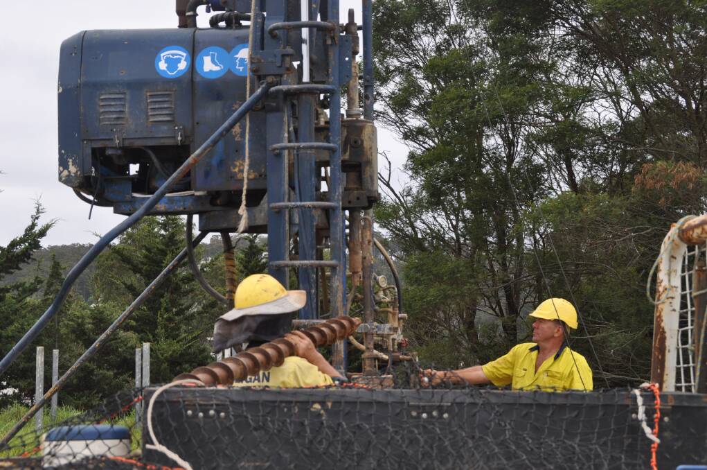 Andrew Whitehead, left and Jim Sheather, from Mulligan Drilling, Khancoban prepare to collect bore hole samples on the Main Street, Merimbula site. 